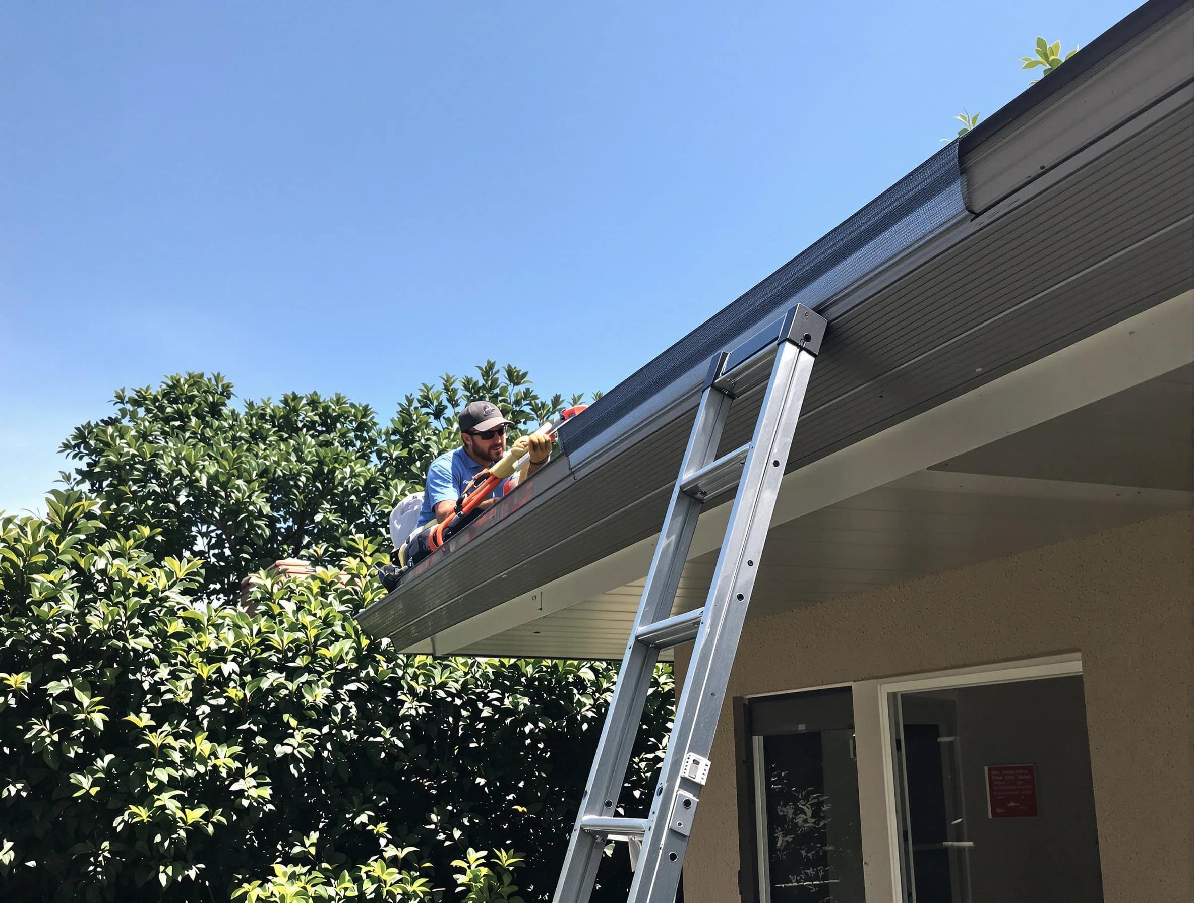 Shaker Heights Roofing Company installing gutter guards for a homeowner in Shaker Heights, OH